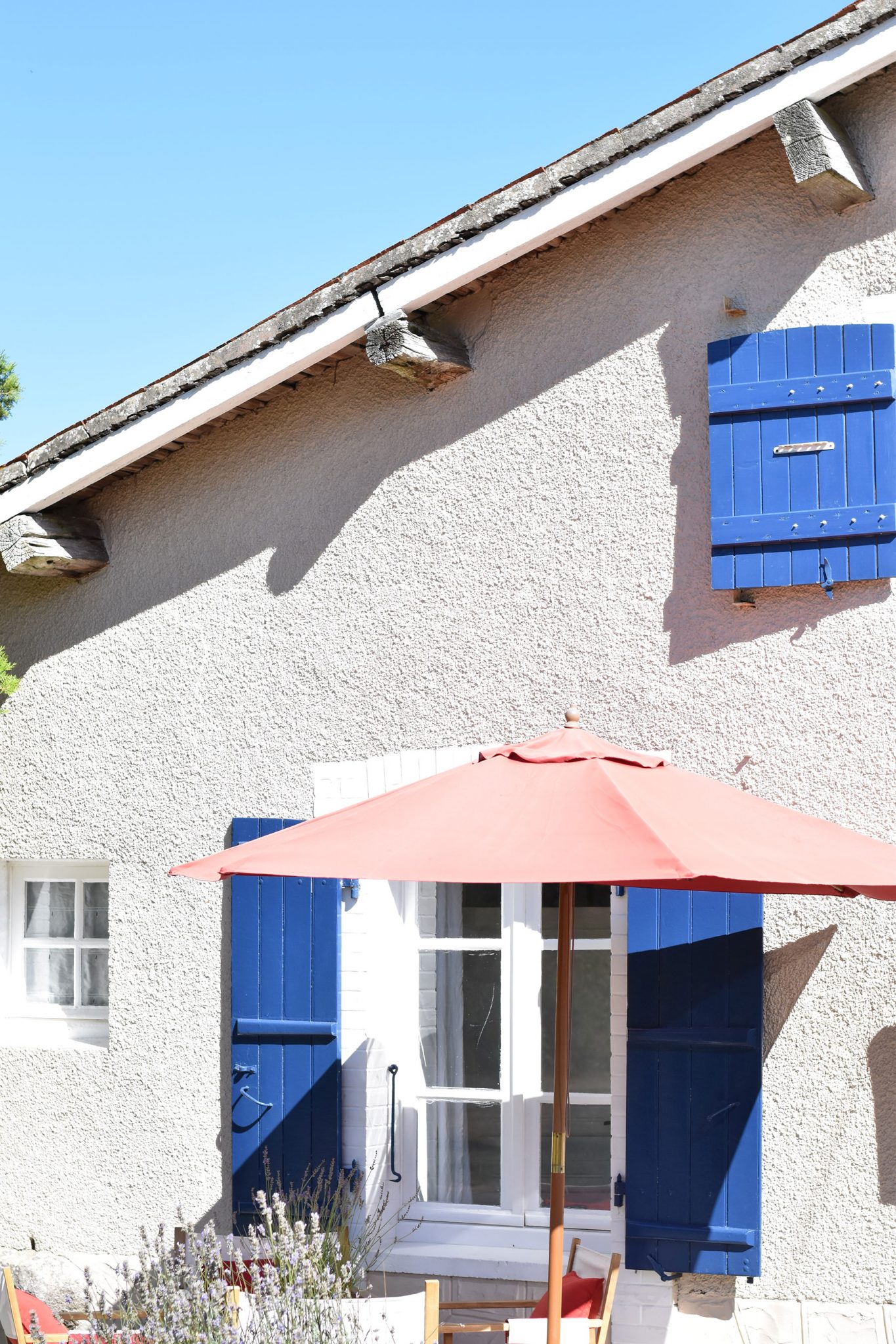 french farmhouse with blue shutters